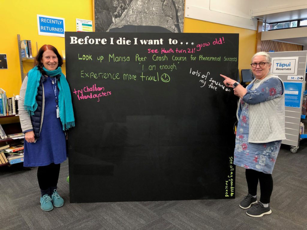 Two women blackboard art project